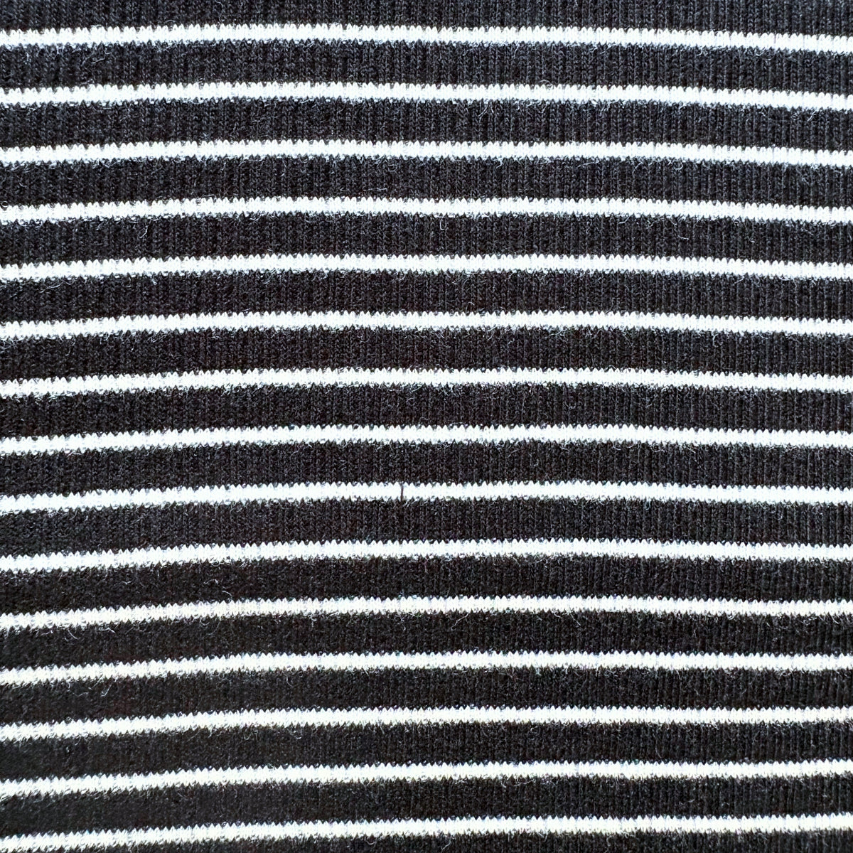Close-up of the black and white horizontal stripe pattern on the Classic Stripes ribbed cotton co-ord set.