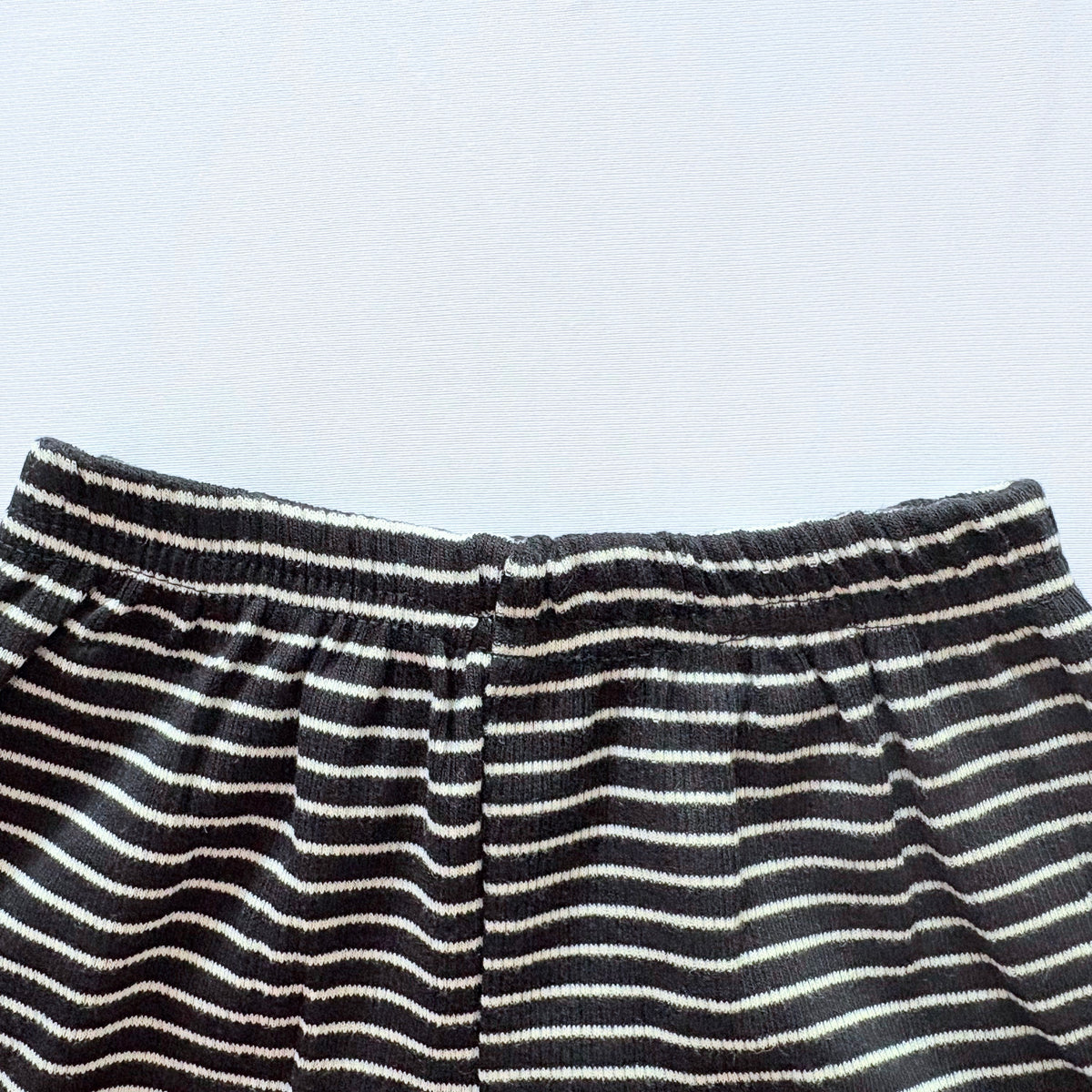 Close-up of the elastic waistband on the Classic Stripes ribbed cotton shorts.