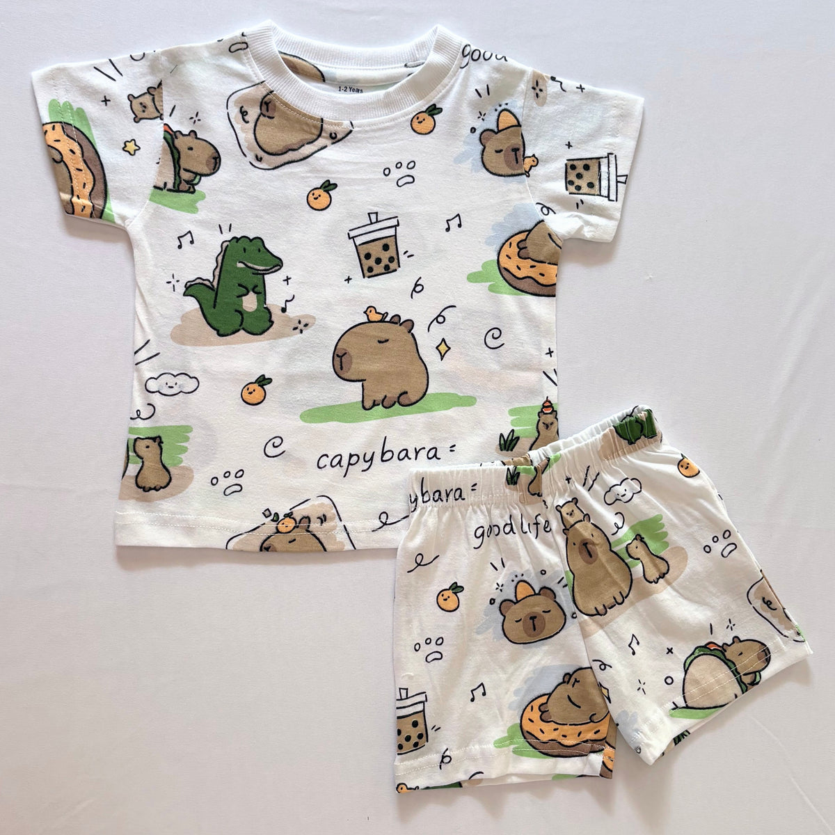 Cozy Capybara Cotton Co-ord Set for kids in White with Capybara, Dinosaur, Bubble Tea and Orange print - Front View.