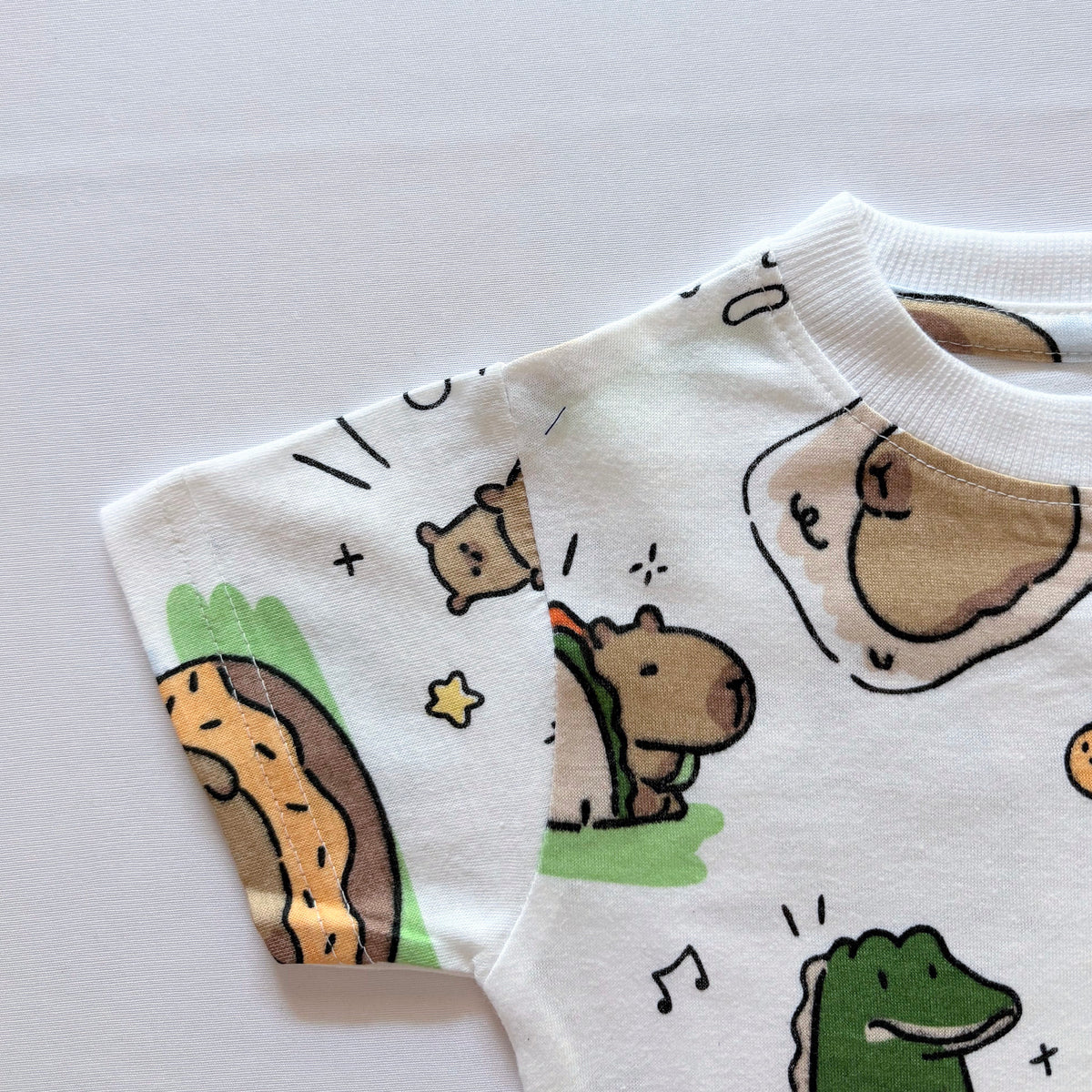 Close-up of the sleeve on the Cozy Capybara Cotton T-shirt.