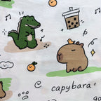Close-up of the Capybara, Dinosaur, Bubble Tea and Orange print on the Cozy Capybara Cotton Co-ord Set.