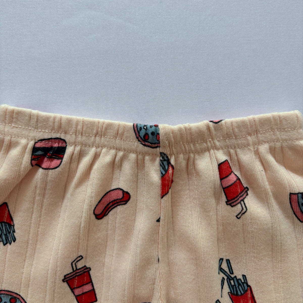 Close-up of the elastic waistband on the Happy Bites Ribbed Cotton Shorts.