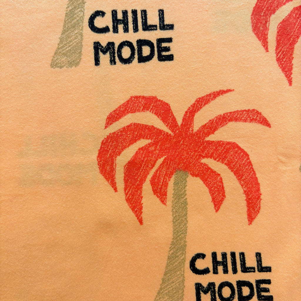 Close-up of the red palm tree print and black "CHILL MODE" text on the Palm Paradise Cotton Co-ord Set.