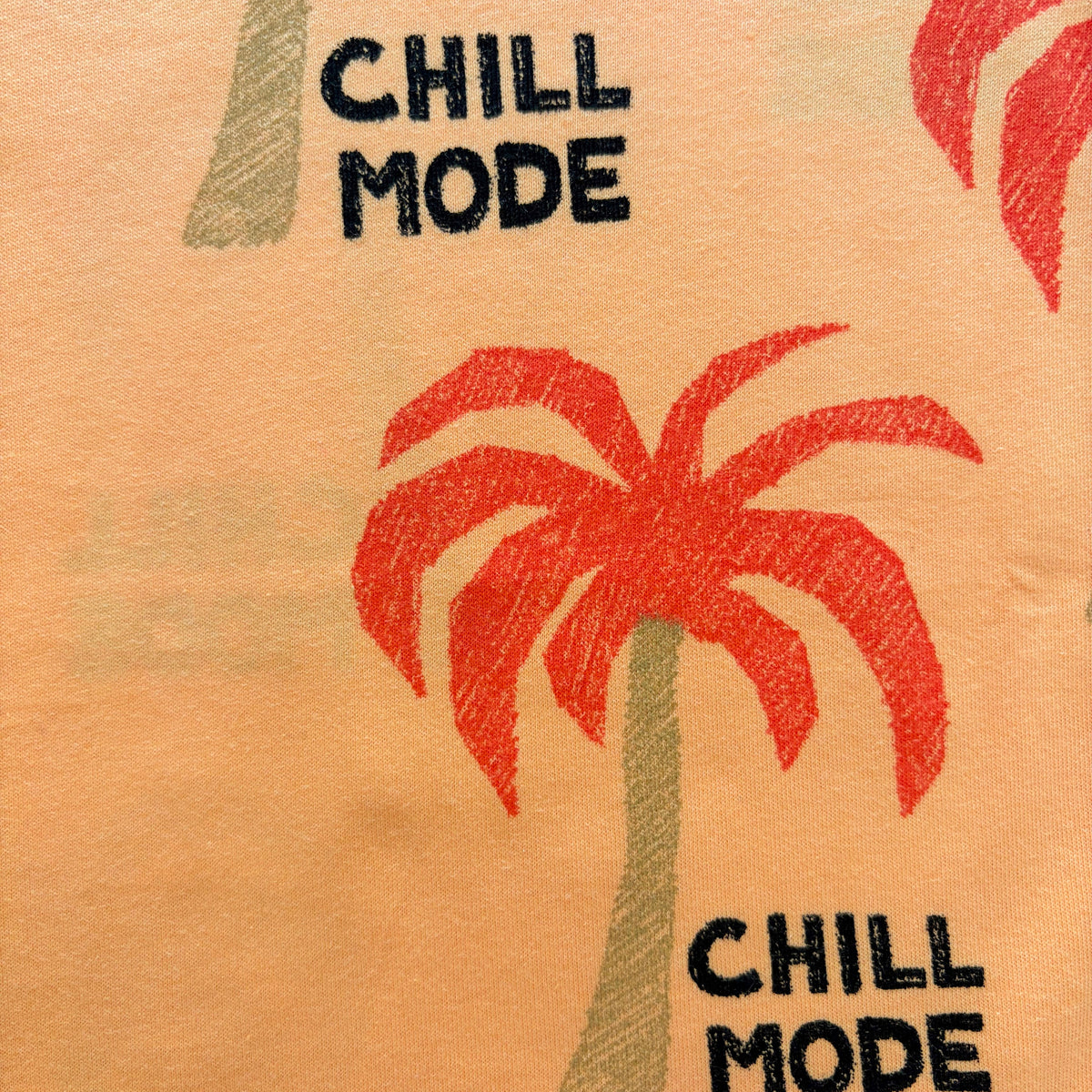 Close-up of the red palm tree print and black "CHILL MODE" text on the Palm Paradise Cotton Co-ord Set.