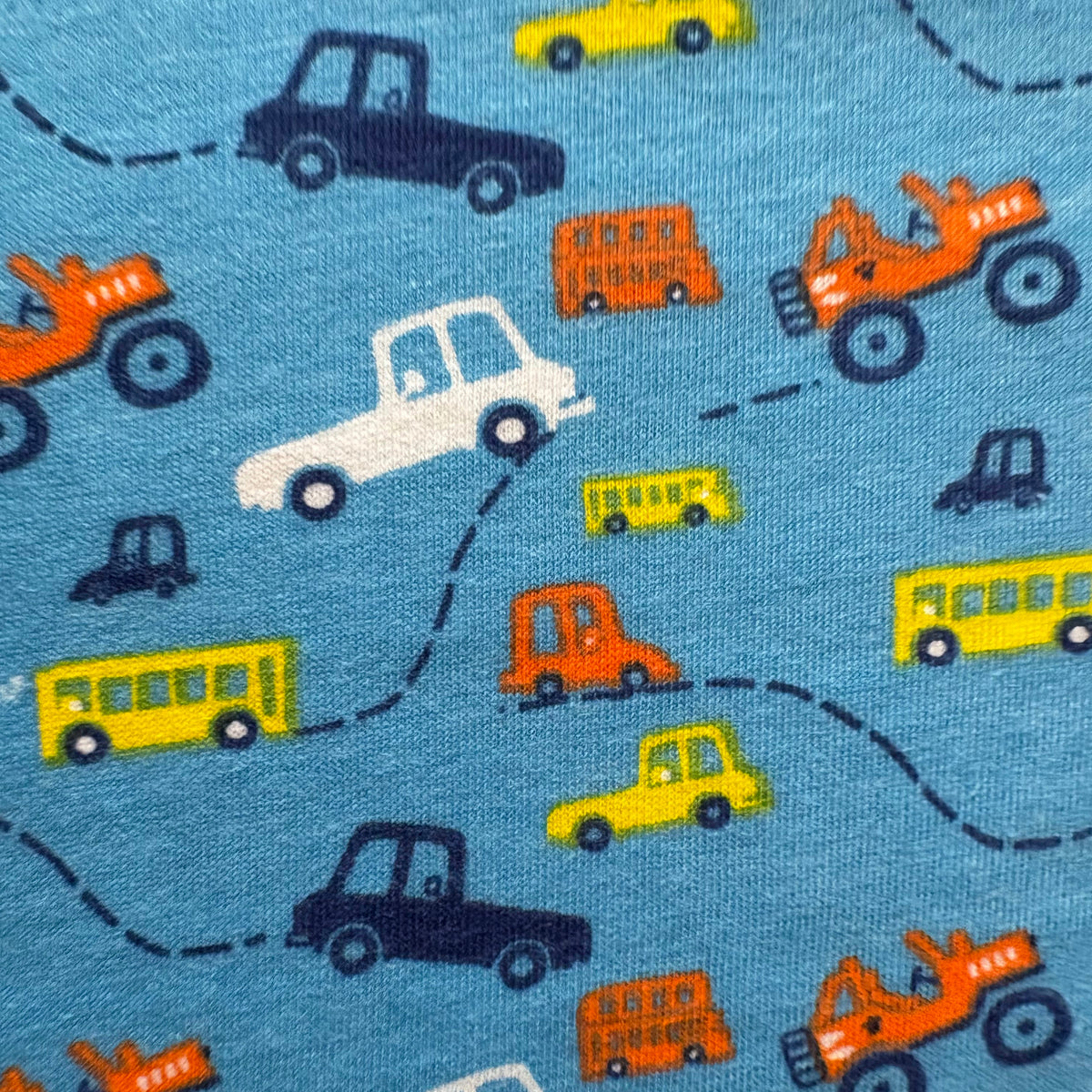 Close-up of the cars, trucks and bus print on the Tiny Travels Cotton Co-ord Set.