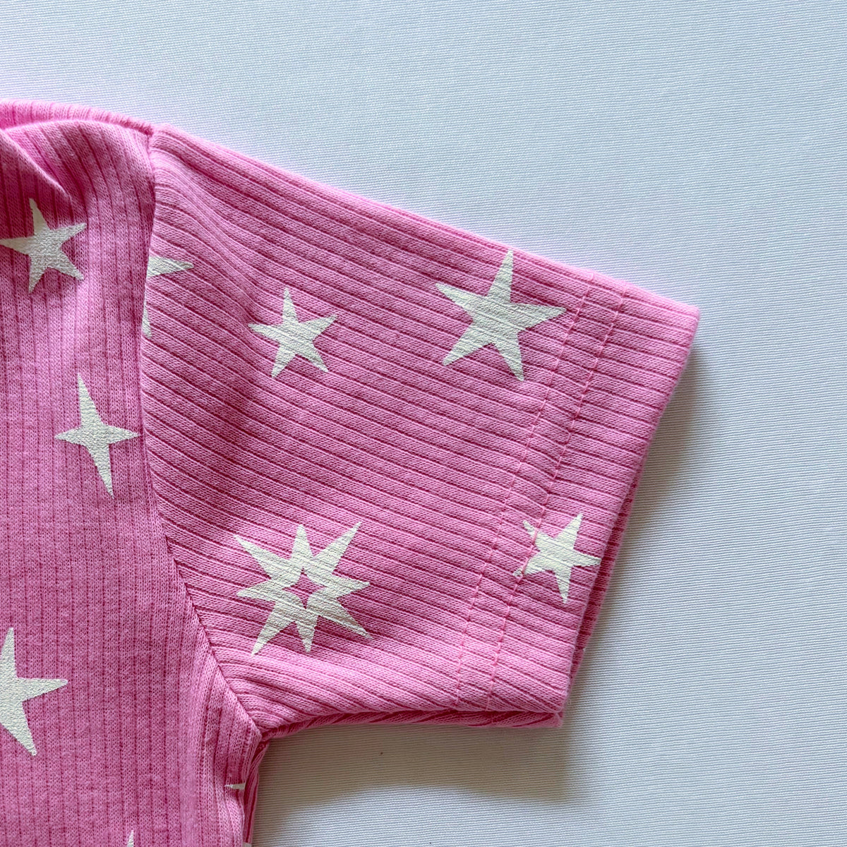 Close-up of the sleeve and the ribbed cotton fabric on the Twinkle Tales T-shirt.